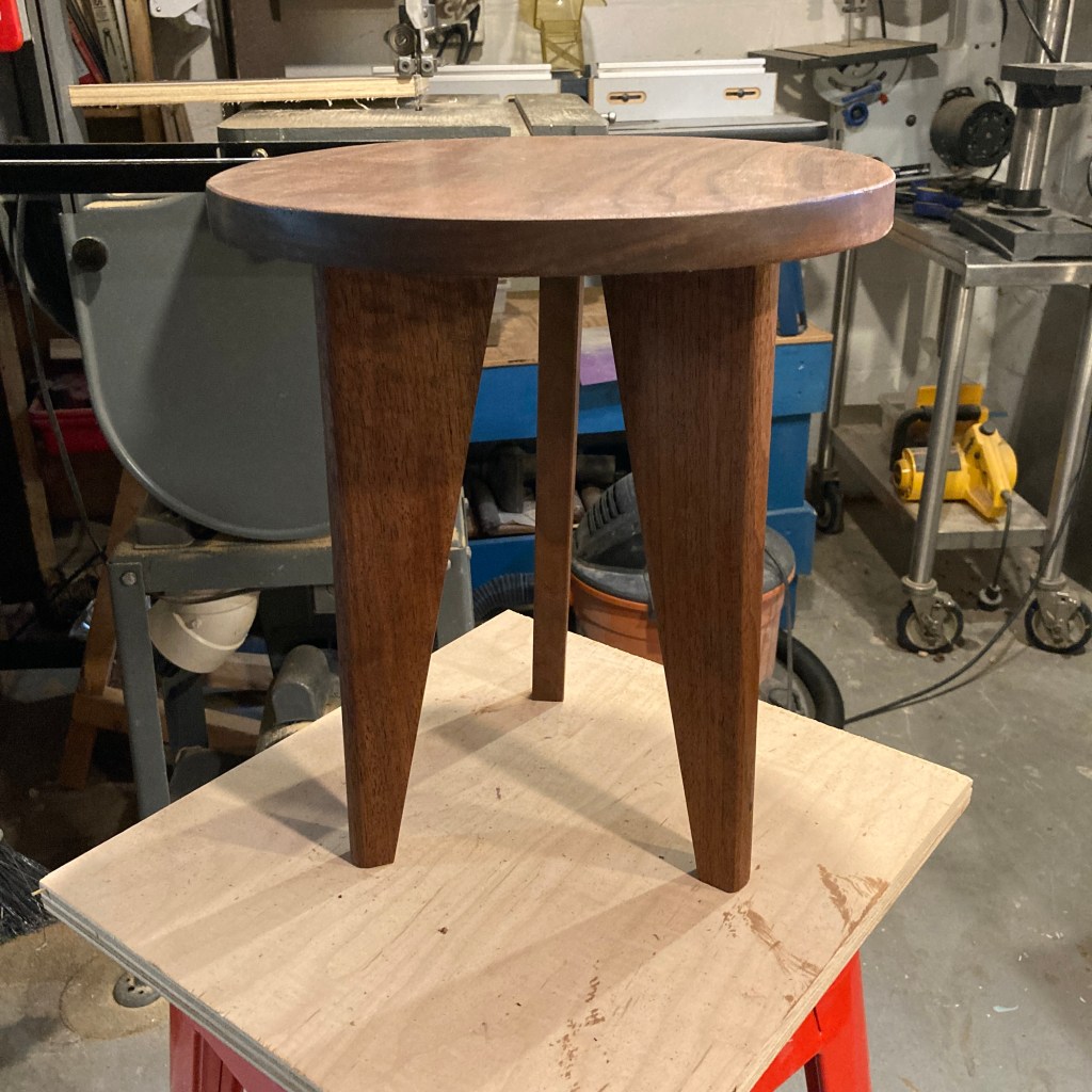 Three legged plant stand made from walnut.